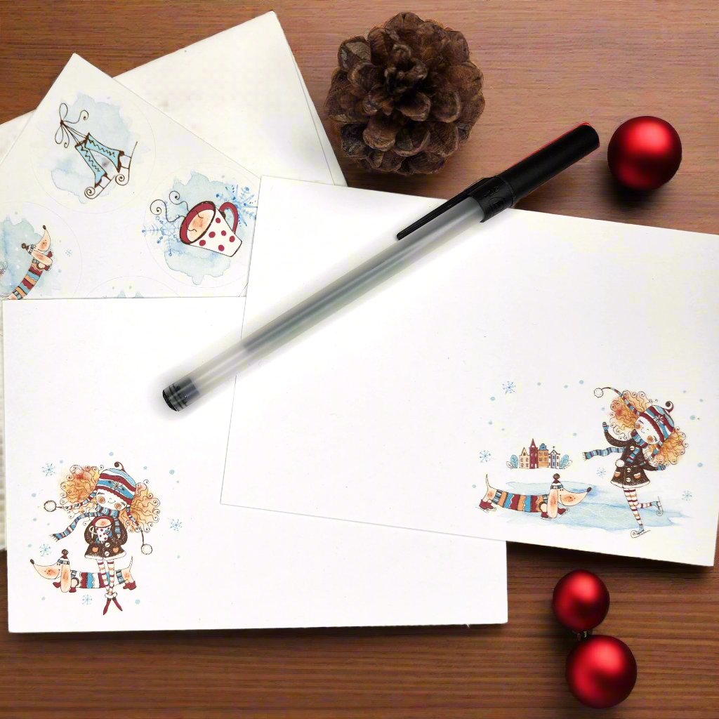 Immie's Christmas stationery set.  Notecard with red headed girl dressed in a brown coat skating with a Weiner dog wearing a sweater watching.  Second notecard is of a Immie dress the same and holding a cup of hot cocoa.  Coordinating stickers and recycled envelopes complete the set.