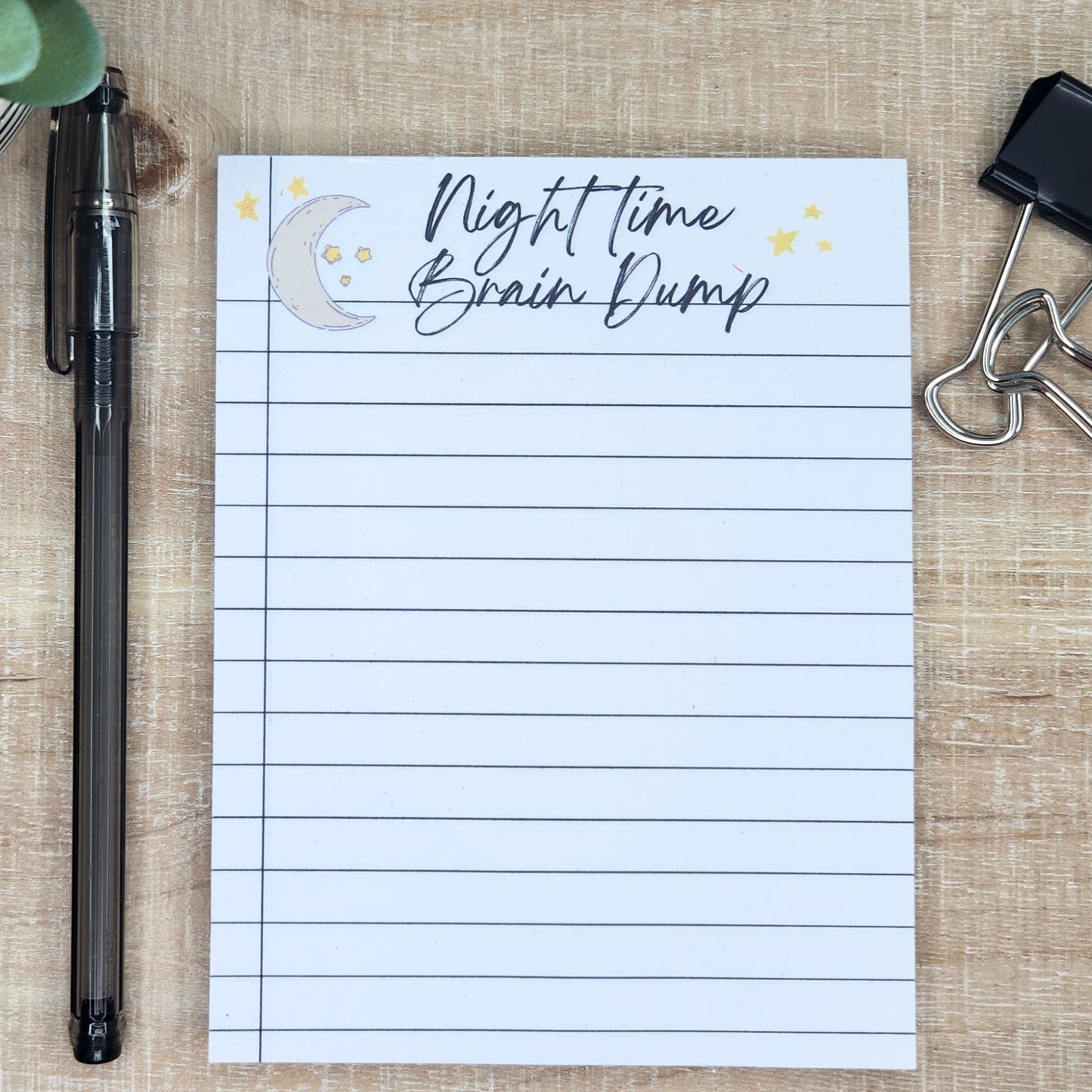 Notepad with moon and starts at the top.  Words Night time Brain dump across the top.  Notepad is lined like a notebook.