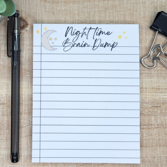 Notepad with moon and starts at the top.  Words Night time Brain dump across the top.  Notepad is lined like a notebook.