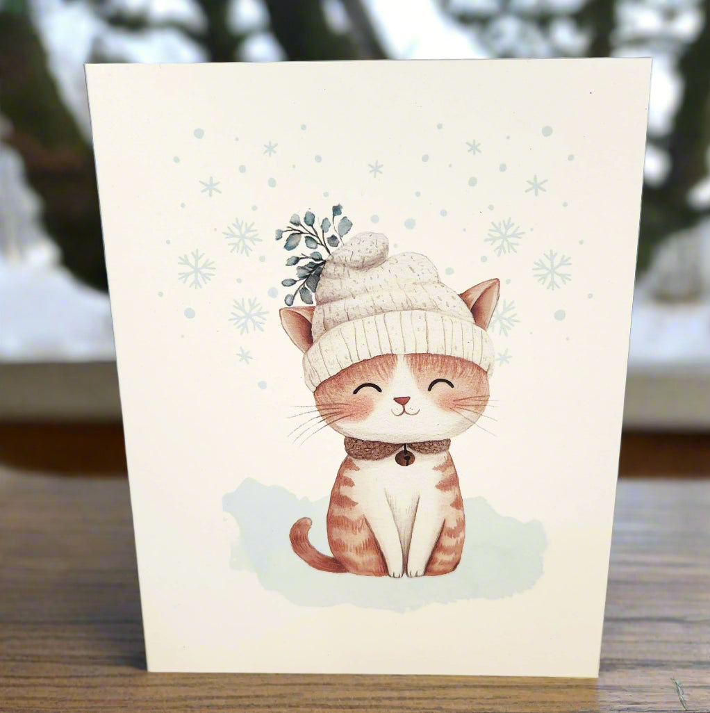 Card with a cute illustration of a cat wearing a knitted hat on a textured surface.