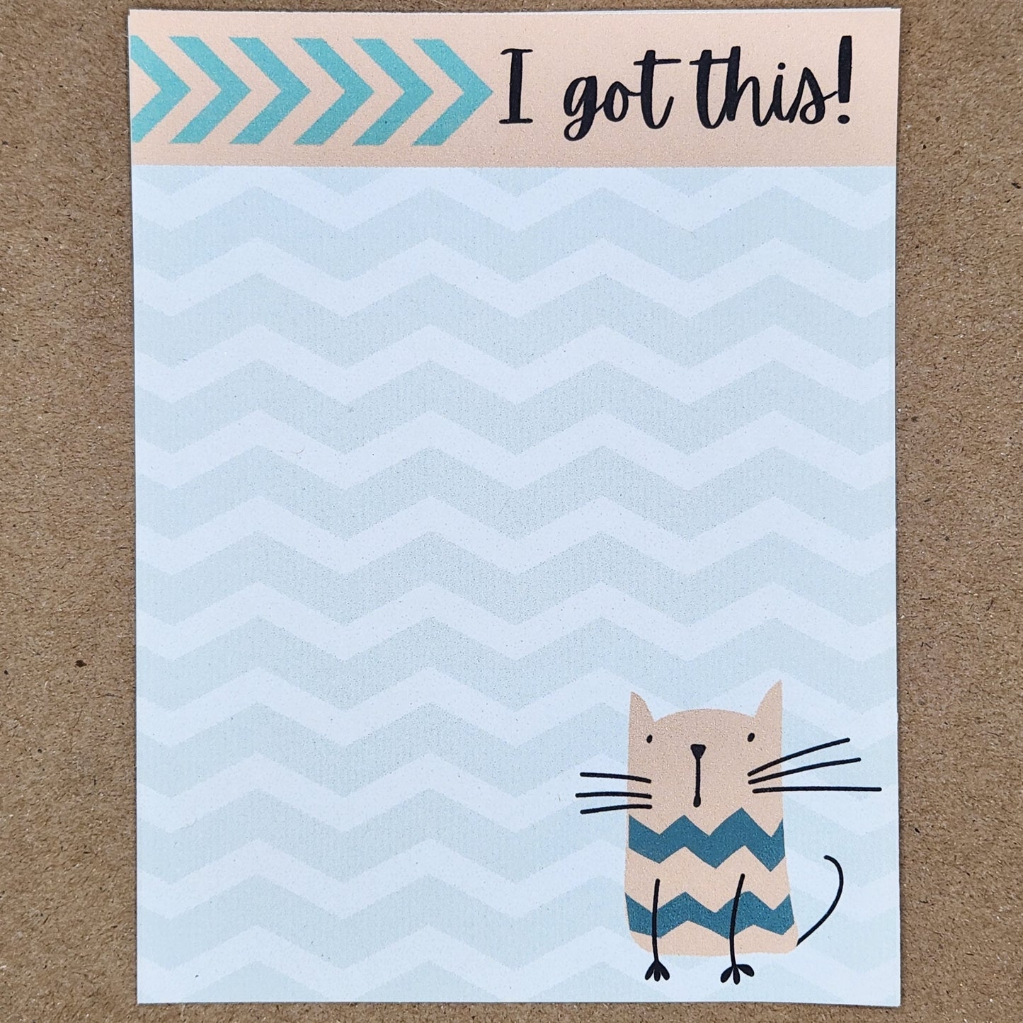 white notepad on tan background. Cat on lower right side of the page. Chevron design throughout the page. Top is accented by a blush border with the words 'I got this!'