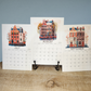 Calendar with illustrations of buildings for July, August, and September on a wooden surface.