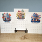 Three calendar pages for October, November, and December with illustrated buildings on a wooden surface.