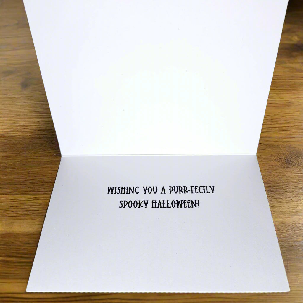 White greeting card with black text on a wooden surface
