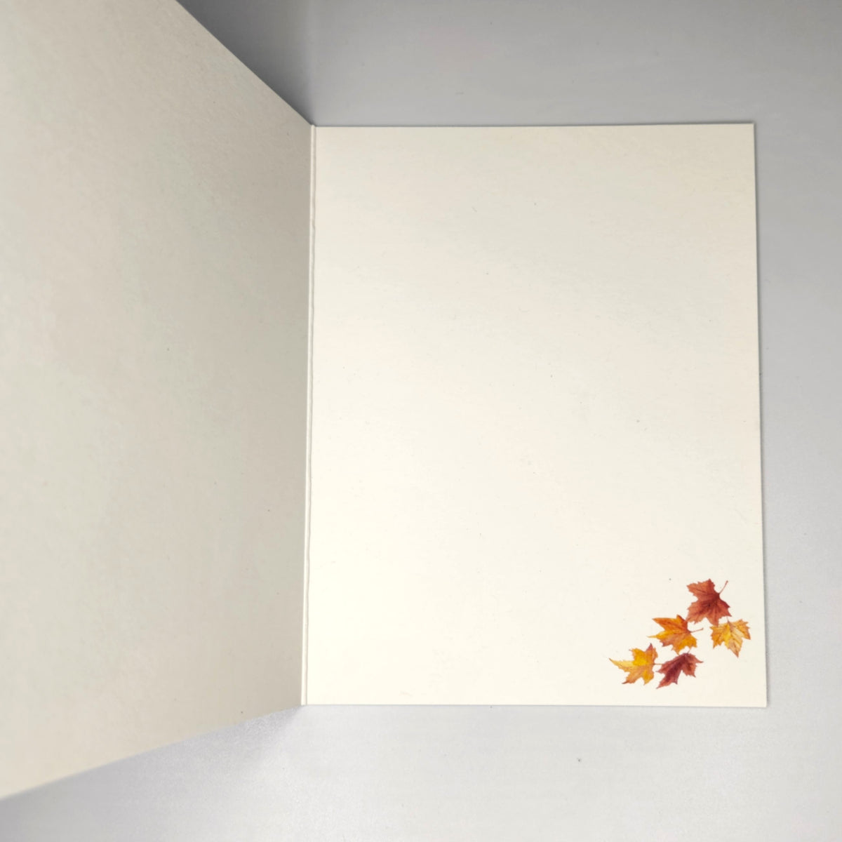 inside of the card showing blank with leaves in the lower right corner