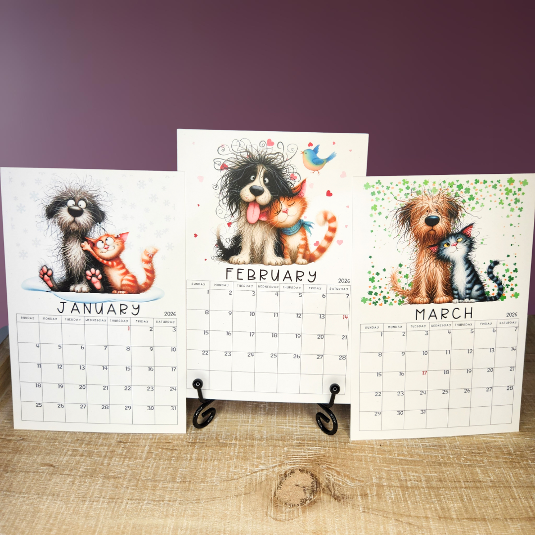 Three calendar pages showing January, February, and March with illustrations of dogs and cats on a wooden surface.
