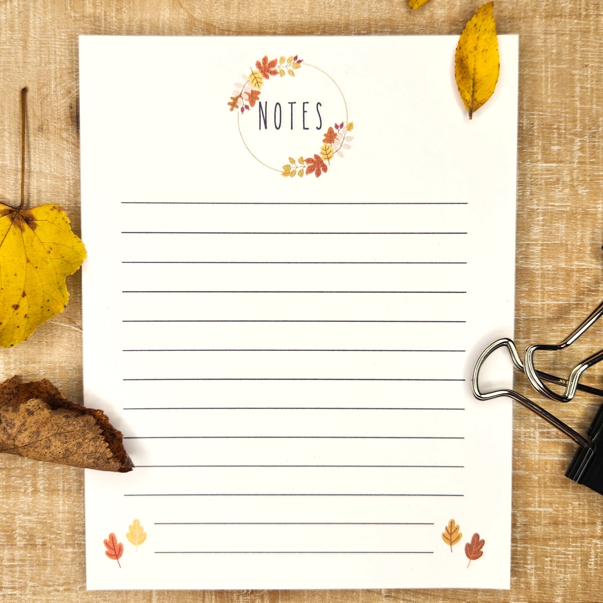 'Notes' in a circle of leaves to this lined notepad