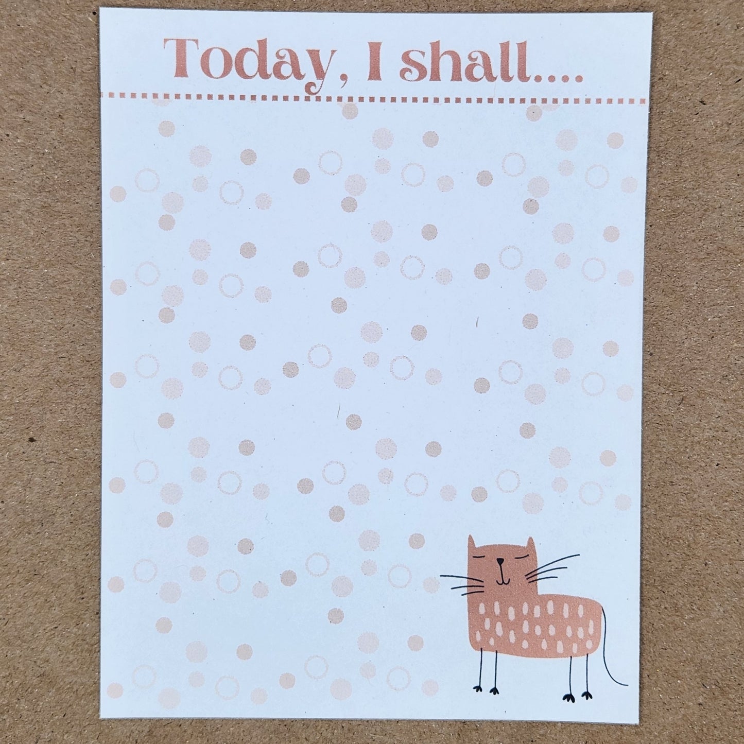 white notepad on tan background. Cat on lower right side of the page. Dot design throughout the page. Top is accented by a blush border with the words 'Today , I shall...'