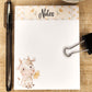 White notepad on blue background. a floral border runs along the top inch of the page with the word Notes in the center. The lower right bottom corner show a cartoon cow sitting holding a flower in it's mouth.