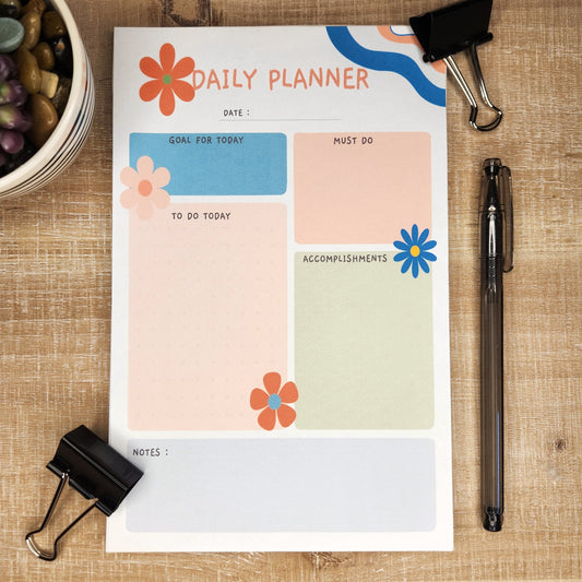 Daily Planner with waves of colors on upper right hand corner.  various flowers accent the page that is filled with different colors of boxes with the headings: date, goal for today, must do, to do today, accomplishments, and notes. 