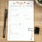 Beautiful half page gratitude journal printed on white paper and laying on a wooden background. Words on the page: gratitude Journal, date, today i'm grateful for, Today's affirmations, something I'm proud of, tomorrow I look forward to , water intake, notes/reminders.
