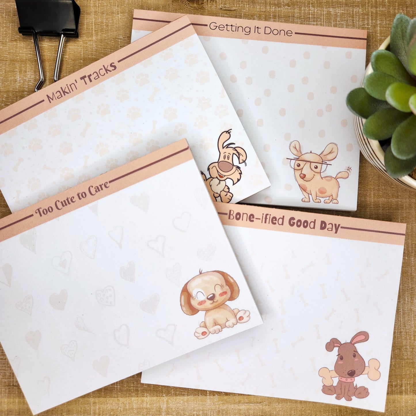 4 white notepads on black background. Each notepad has a beige border on the top and cute puppy on the bottom right corner.